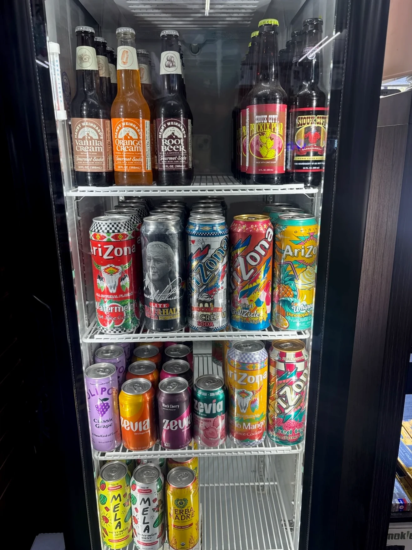 Cooler stocked with sodas and specialty drinks